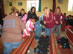Giving out gloves at Betania church in Chambitola on Thursday